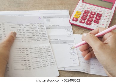 Hand Checking Document Monthly Expense Of Credit Card With Passbook Bank And Payment Slip Of Bank