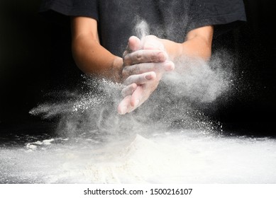 Hand chef clap with white flour clouds splash, baker preparing - Powered by Shutterstock