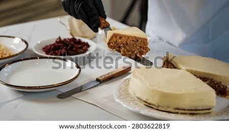 a hand of chef do working as dressing the face of a piece of cake in catering cuisine