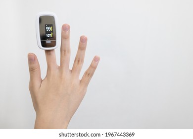 Hand Of Child Girl With Fingertip Pulse Oximeter On Finger For Examination Of The Lung Disease,checking For Coronavirus COVID-19 Infection From Oxygen Saturation At Home,measuring Heart Rate (pulse)