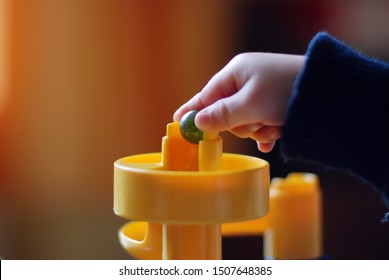 Hand Of A Child Playing With A Marble Run