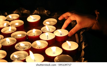 Hand Of The Childwho Lights A Candle During The Religious Ceremony