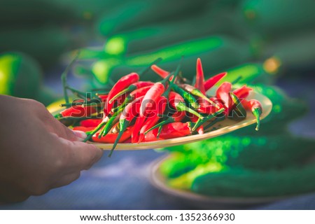 Hand with chili in a bowl,Chili that is sold at the market countryside,Organic vegetables