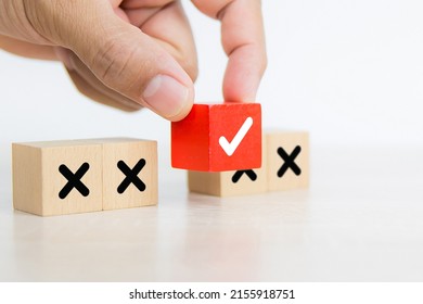 Hand Choose Check Mark On Cube Wooden Toy Block Stack With Cross Symbol For True Or False Changing Mindset Or Way Of Adapting To Change Leader And Transform Quiz Answer And Poll Concept.