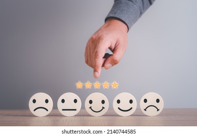 Hand choose circle wood with happy smile face, good feedback rating,positive customer review, experience, satisfaction survey ,mental health assessment, child wellness,world mental health day concept