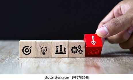 Hand Choose Cube Wooden Block Stack With The Key On Business Strategy Icon With Graph And Arrow Bullseye Of Strategic Plan And Marketing Organization Management For Success And Growth Concepts.