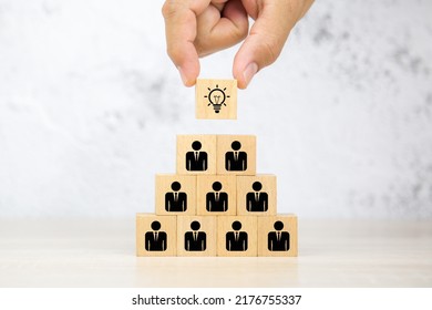 Hand Choose Cube Wooden Block Stack With Lightbulb On Human Icon Stack For Idea And Leadership And Business Team Or Creative Thinking And Human Resources For Teamwork Or Team Player.