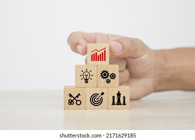 Hand Choose Cube Wooden Blocks Stack With Graph Icon On Business Strategic Plan Concept Of Financial Research For Management To Success And Growth And Strategy Planning.