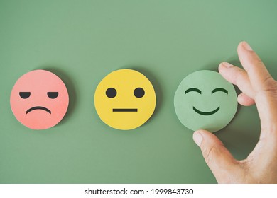 Hand Choose Green Paper Cut, Happy Smiling Face On Green Background For Mental Health Assessment ,positive Thinking, World Mental Health Day ,customer Review, Experience, Satisfaction Survey Concept