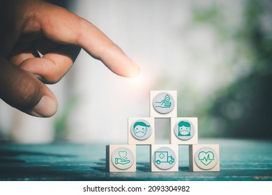 Hand Chooses Icons Healthcare Medical Symbol On Wooden Block. Vaccine, Rising Growth.COVID-19. Photo Medical And Technology Concept.