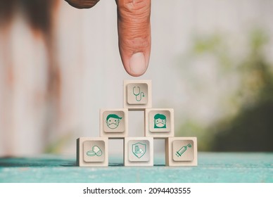 Hand Chooses Icons Healthcare Medical Symbol On Wooden Block. Vaccine, Rising Growth.COVID-19. Photo Medical And Technology Concept.