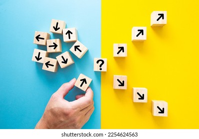 Hand choosing a block with arrows. Path leads to successful decision concept.