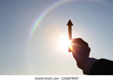 Hand choosing and holding an arrow rising high and stocks finance economy industry growth investment target success concept
 - Shutterstock ID 2236878987
