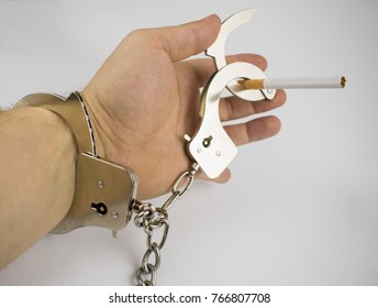 The hand and the cigarette are handcuffed. The concept of smoking habit. - Shutterstock ID 766807708