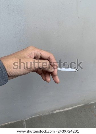 Hand with cigarettes side view