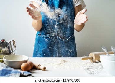 Hand Clap Of Professional Women Baker 
 Chef With Bowl For Cooking And Baking Utensils With Splash Flour On White Background