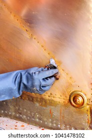 Hand Cleaning Of The Brass Lining Of An Old Wooden Door