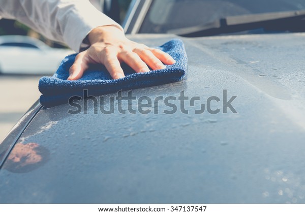 Hand\
cleaning car with microfiber cloth,wipe\
outside