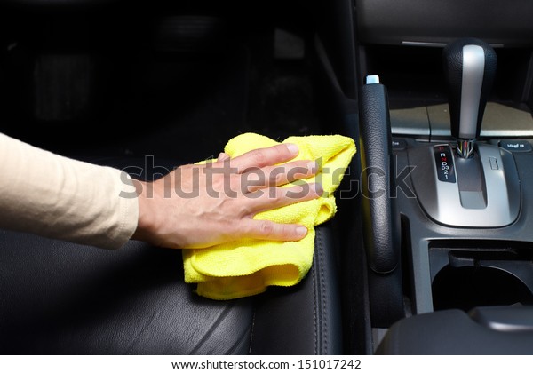 Hand cleaning car\
seat.