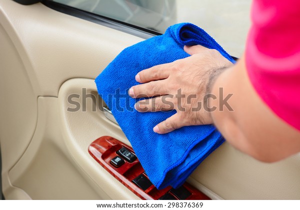 Hand cleaning interior car door panel with
microfiber cloth