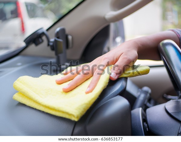 Hand cleaning interior car steering wheel with\
microfiber cloth