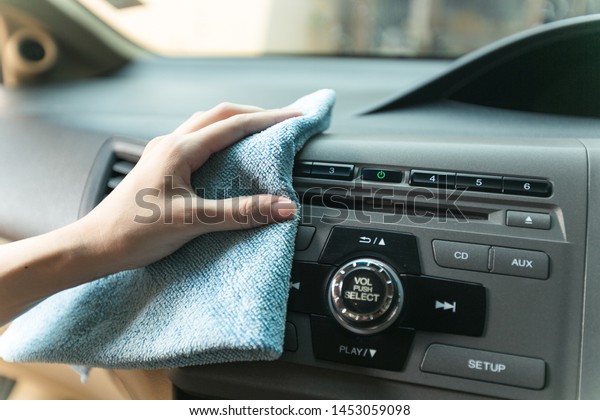 Hand cleaning Interior modern car with Microfiber\
and cleaning console car.