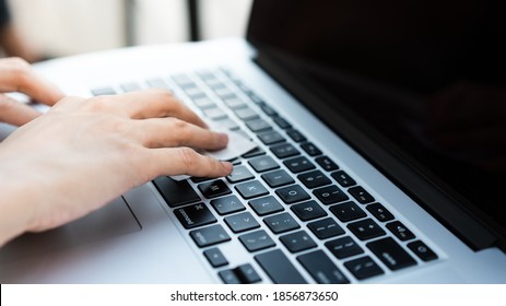 A Hand Is Cleaning  Laptop Keyboard With Alcohol Swab