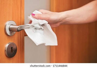 Hand Cleaning Metal Door Handle With Paper Tissue Towel, Closeup Detail - Coronavirus Covid-19 Spread Prevention