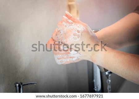 Hand cleaning and soap desinfection with hot water. Hygiene anti-virus concept.
