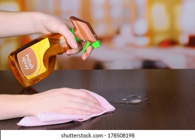 Hand Cleaning Wooden Table With Furniture Polish