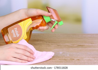 Hand Cleaning Wooden Table With Furniture Polish