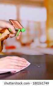 Hand Cleaning Wooden Table With Furniture Polish