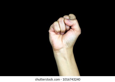 Hand with clenched fist isolated against a black background