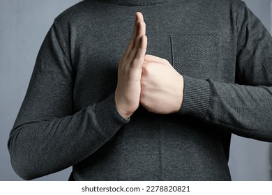 Hand clenched in fist rests in open hand in palm. Gesture of readiness for battle, perseverance - Shutterstock ID 2278820821