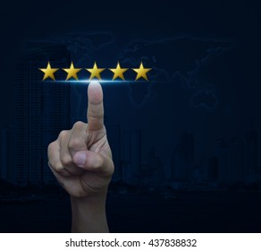 Hand click on five gold stars to increase rating over map and city tower, Feedback concept, Elements of this image furnished by NASA - Shutterstock ID 437838832