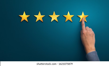 Hand of client giving a five star rating on blue background, panorama, copy space. Service rating, satisfaction concept - Shutterstock ID 1621075879