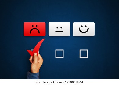 Hand Of Client Show A Feedback With Bad Smile Face Card. Service Rating, Satisfaction Concept