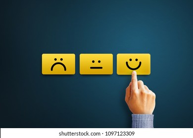 Hand of client show a feedback with smiley face card. Service rating, satisfaction concept