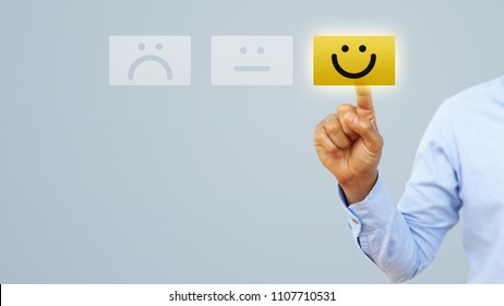 Hand of client show a feedback with smiley face card. Service rating, satisfaction concept