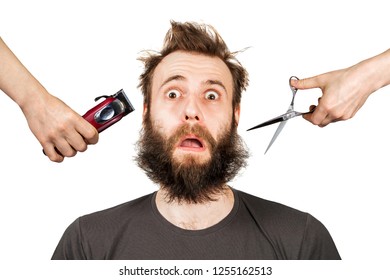 Hand With Clipper And Hand With Scissors Cut Overgrown Unshaven Guy With A Beard On A White Isolated Background