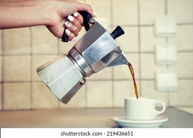 Hand Close Up Pouring Espresso Coffee In A Cup