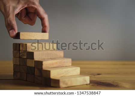 Hand Closer up hands of businessmen,stacking wooden blocks into steps,Concept of business growth success - image