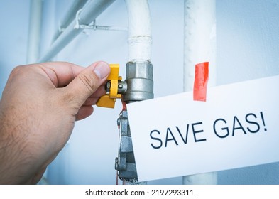 A Hand Closes A Gas Valve On A Home Gas Pipeline With The Inscription 