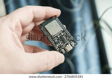 In hand, close-up of the ESP development board