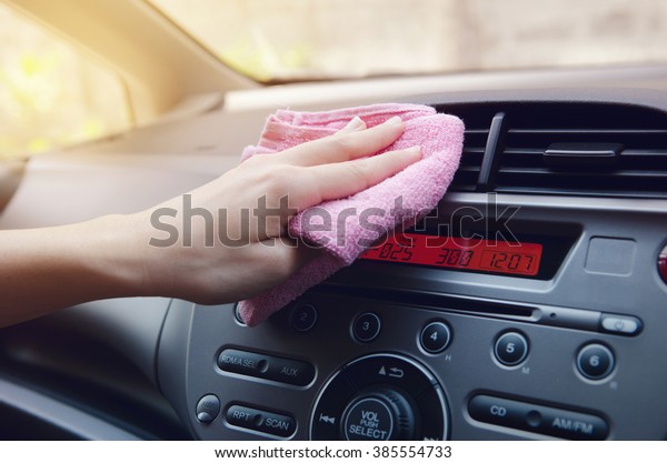 Hand with cloth polishing\
car.