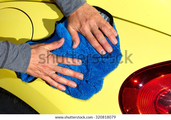 Hand with\
cloth washing a car. Waxing and\
polishing.