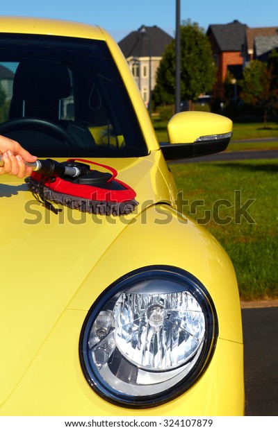 Hand with\
cloth washing a car. Waxing and\
polishing.