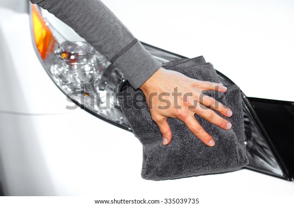 Hand with
cloth washing a car. Waxing and
polishing.