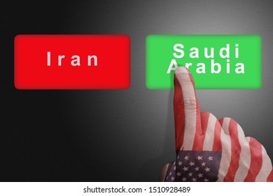 Hand With The Colors Of The American Flag Chooses Saudi Arabia Against Iran: Concept Of US Political Support For Saudi Arabia Against Iran