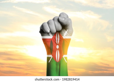 Hand In Colors Of Kenyan Flag At Sunrise